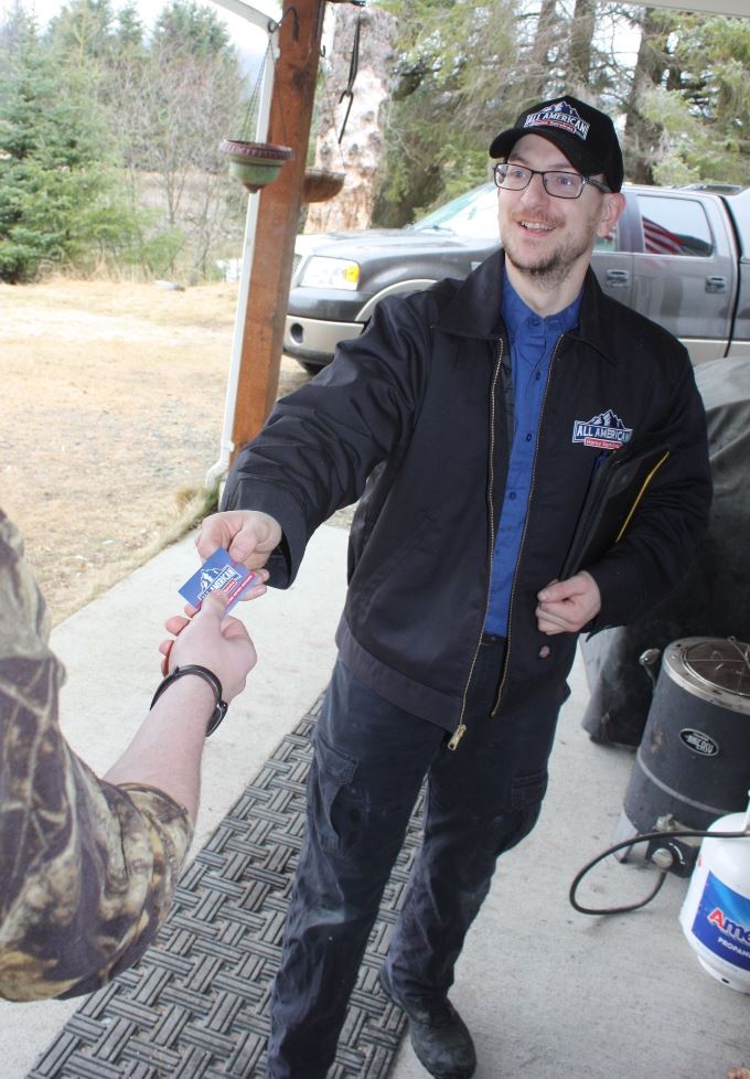 Technician providing business card to client